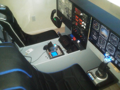 A nice shot of the cockpit.  Notice how I made sure to engineer enough center console space for 2 frosty pints to be parked without getting in the way of flight ops.  Yoke on the left, stick on the right.  I even scratch-built a panel with a powered USB hub to power panel lights, tablets, and other USB devices.  Currently only the left seat is a rumble seat.  The right seat is a cheap knockoff that needs to be replaced.  Rumble seats kick ass in sims.