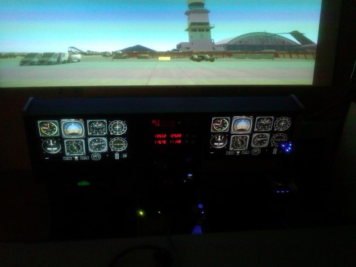 This is a nice view of the cockpit and looking out at the KLGB tower (using the map available on www.splane-scenery.com) The projected screen is just over 7' wide, and 4' tall.  Giant projected screens are far more immersive than small monitors.  When I bank the simulator, my passengers tilt their heads because they feel like they are really flying.  You actually have to turn your head to look around.